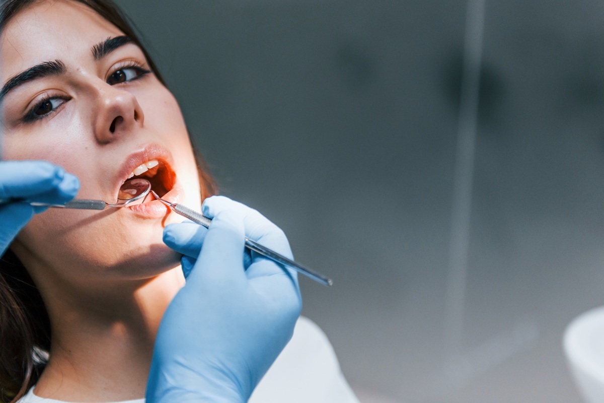 Dentist performing root canal treatment on patient to preserve natural tooth.